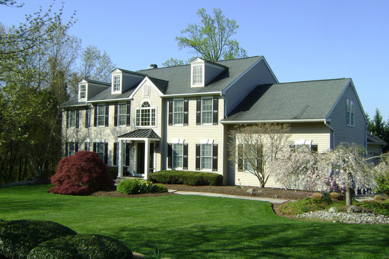 Traditional home with expansive portico and two-story addition