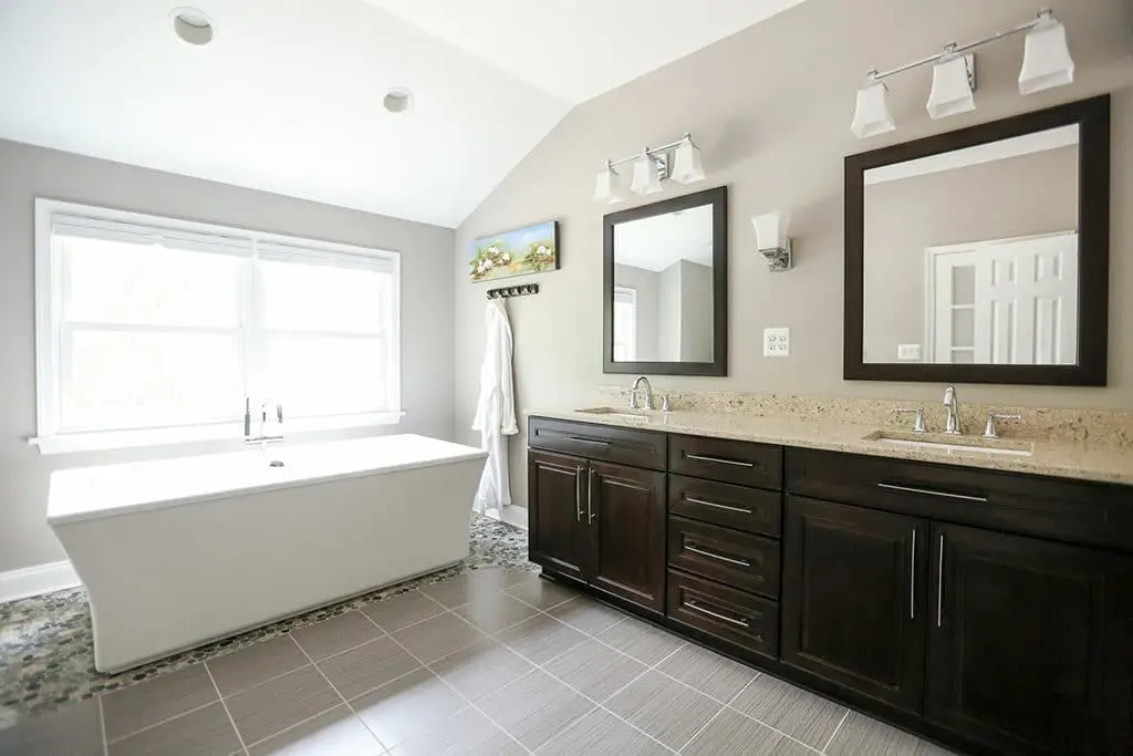Master suite remodel with large free standing bathtub and his & hers vanities.
