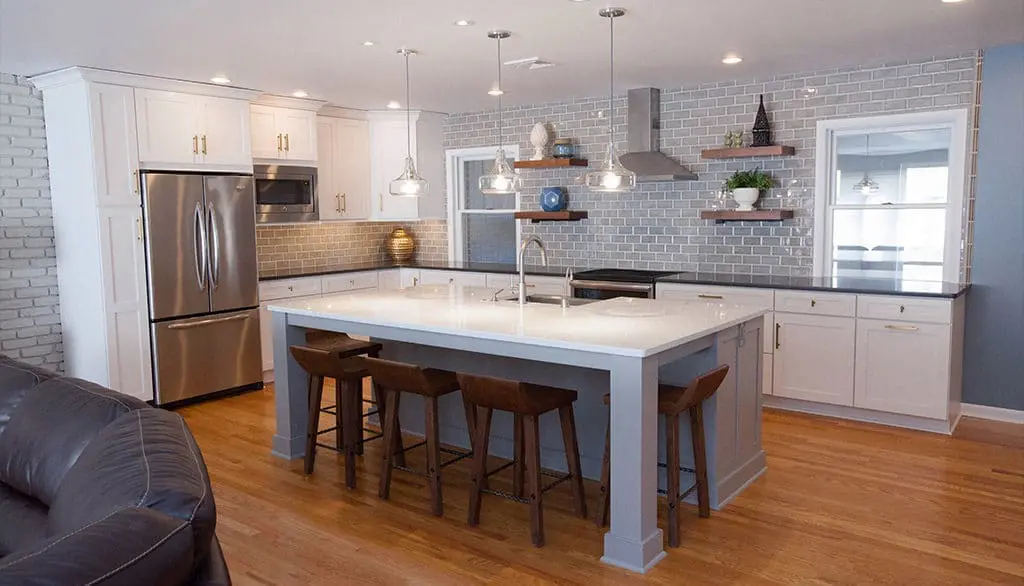 Remodeled kitchen with wood flooring and large island with bar stools