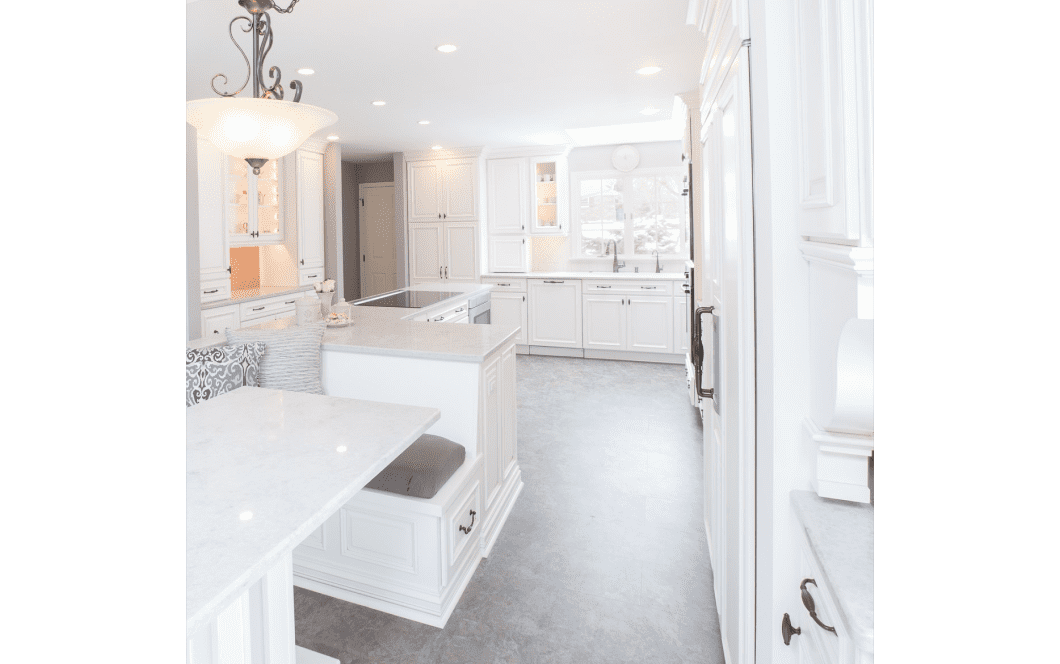 Classic white kitchen renovation with grey concrete floor and custom dining area booth