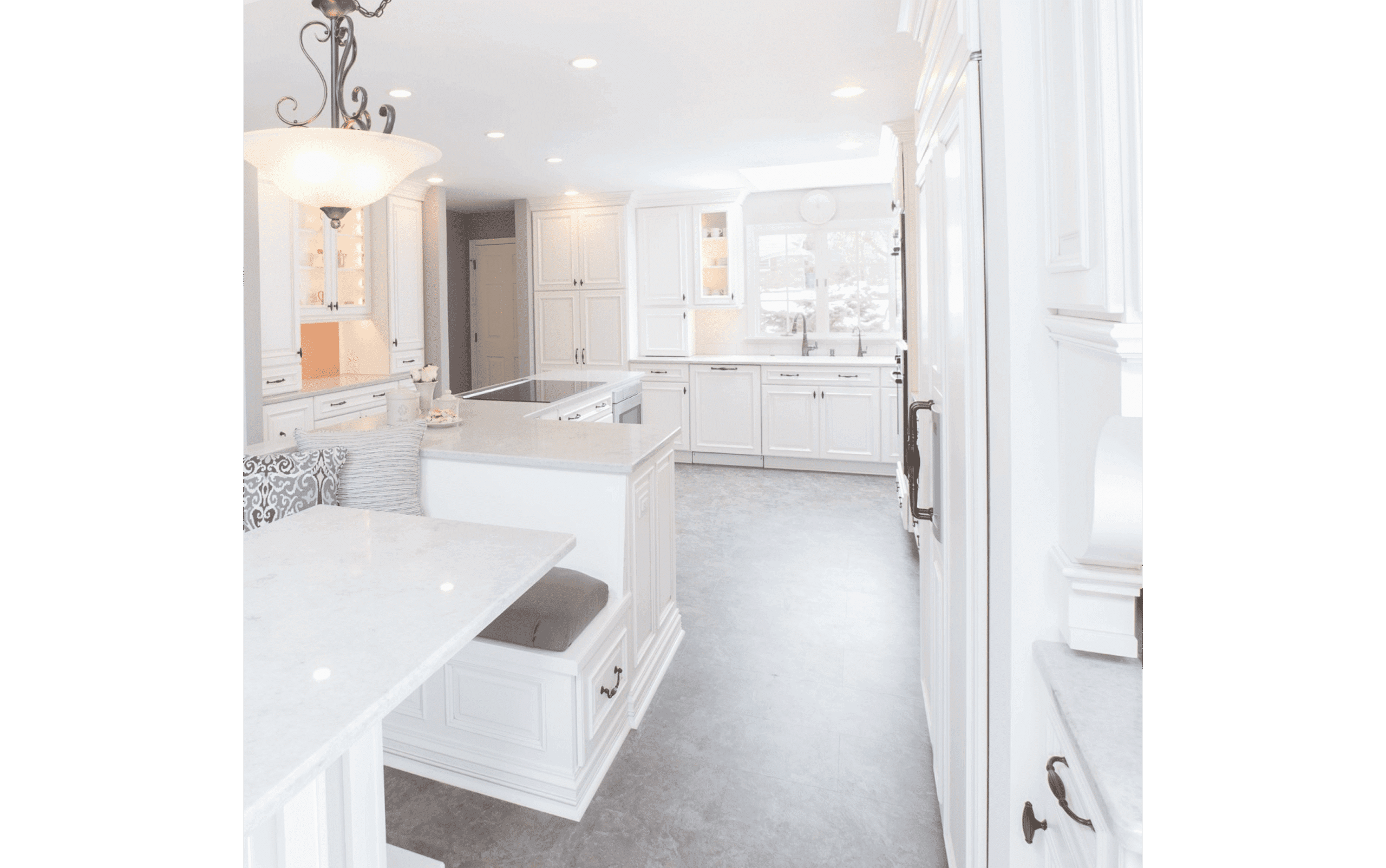 Classic white kitchen renovation with grey concrete floor and custom dining area booth