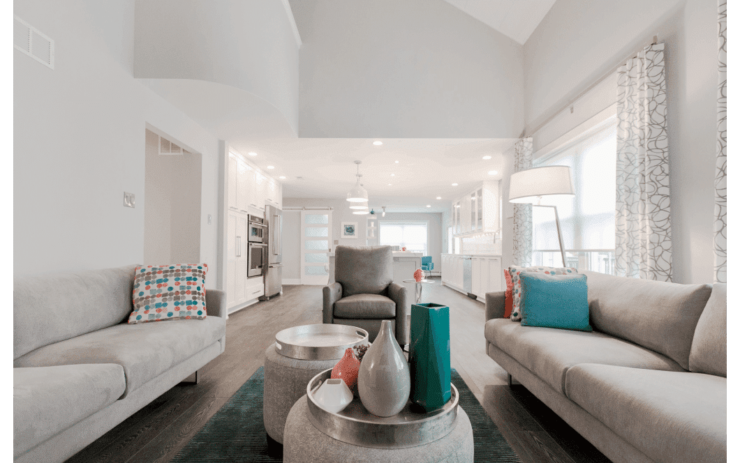 Open-concept two-story family room flowing into expansive kitchen and dining area