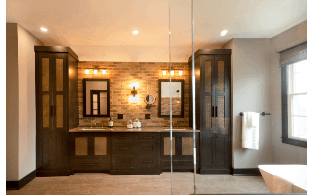 Large primary bath with dual vanity, recessed lighting, large window letting in natural light, glass shower enclosure, and corner view of bathtub