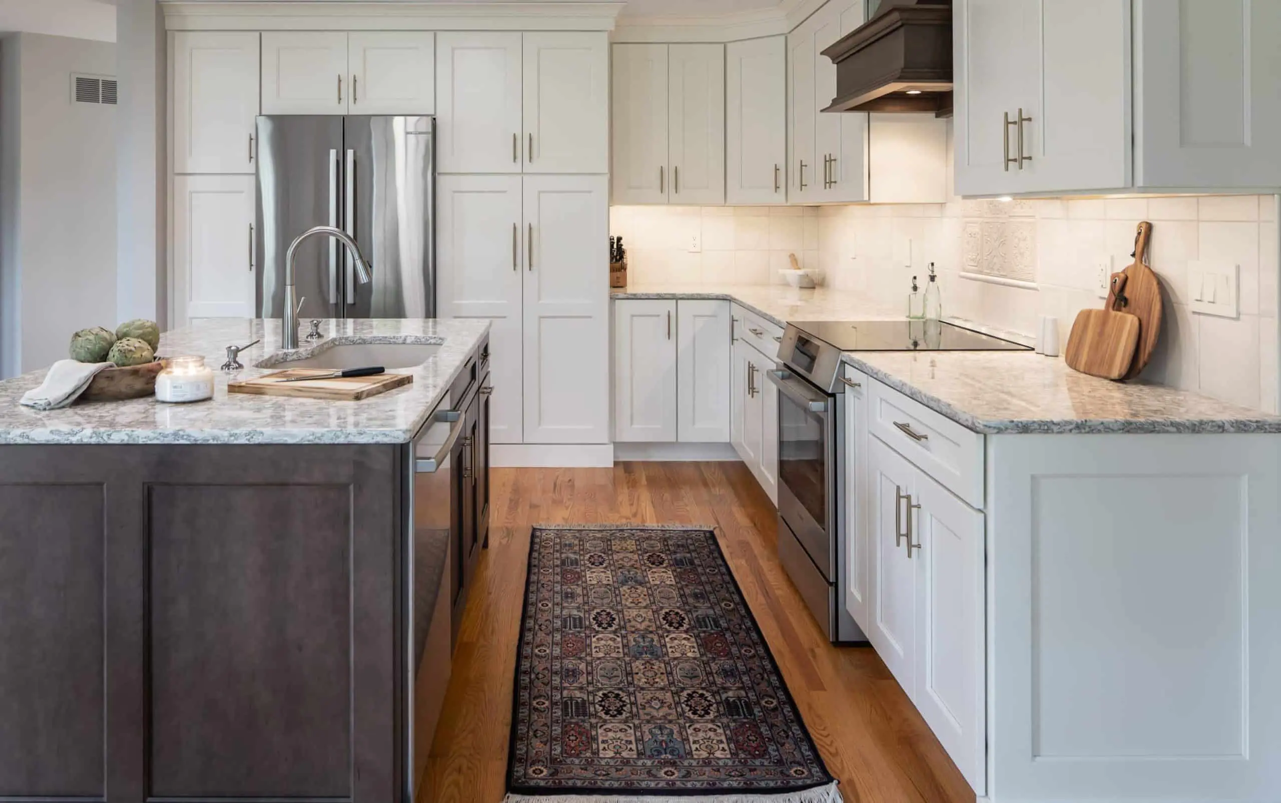 Updated grey kitchen with contrasting dark wooden island and floor-to-ceiling cabinet storage