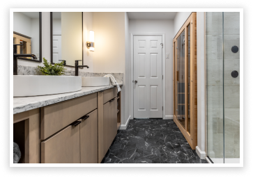 luxury bathroom remodel black quartz tile flooring glass shower white granite countertop