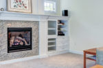 living room remodel with built in storage and gas fireplace