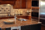 kitchen remodel with sink in the island and tile backsplash