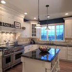 kitchen remodel with recessed lighting and stone backsplash on tall white cabinetry