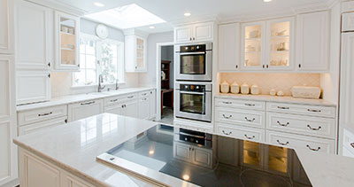 kitchen remodel with white cabinets and double ovens in the cabinet

