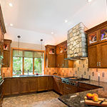 kitchen remodel with stone vent above stove