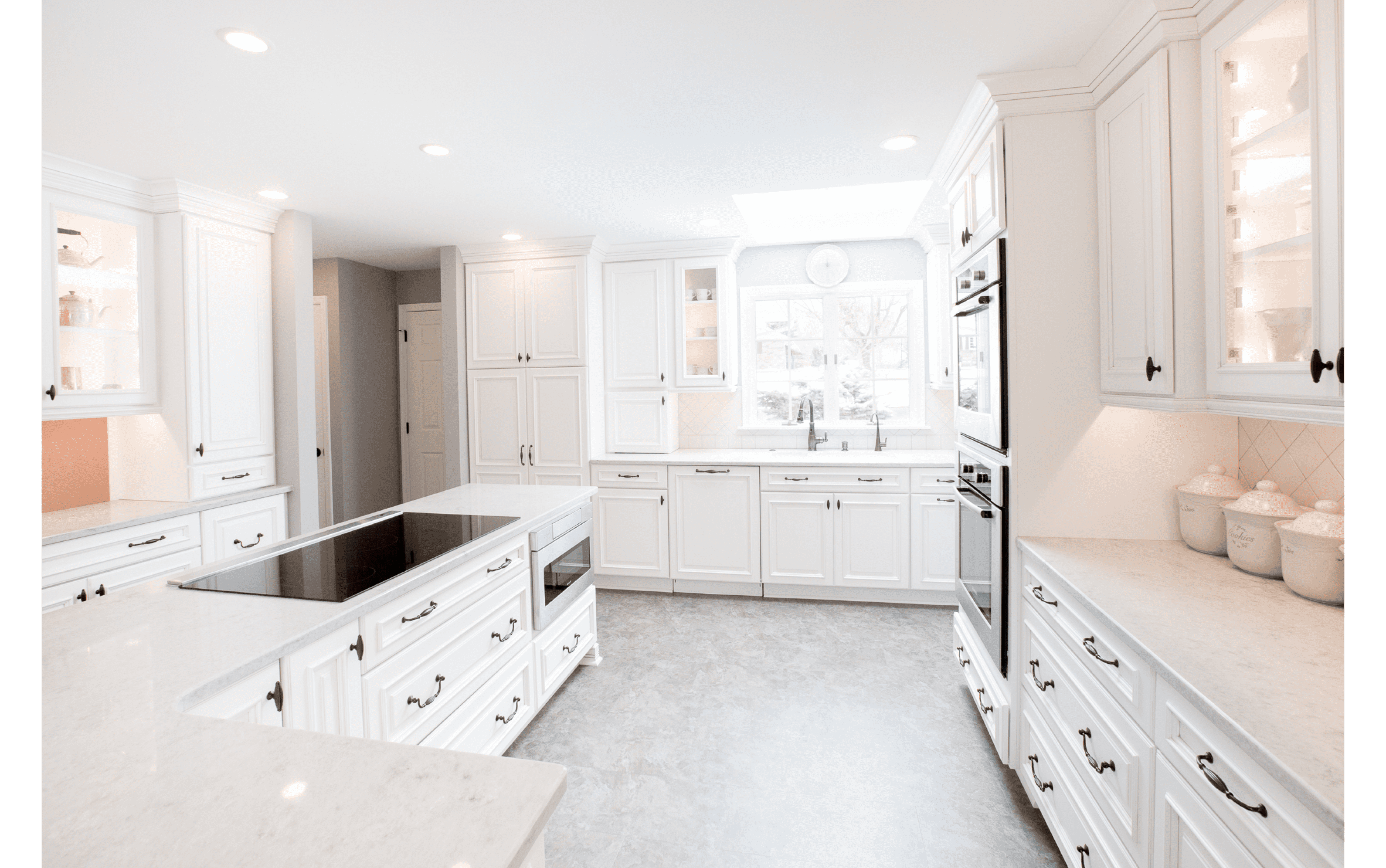 kitchen renovation with white cabinetry mixed glass doors black finishes recess lighting
