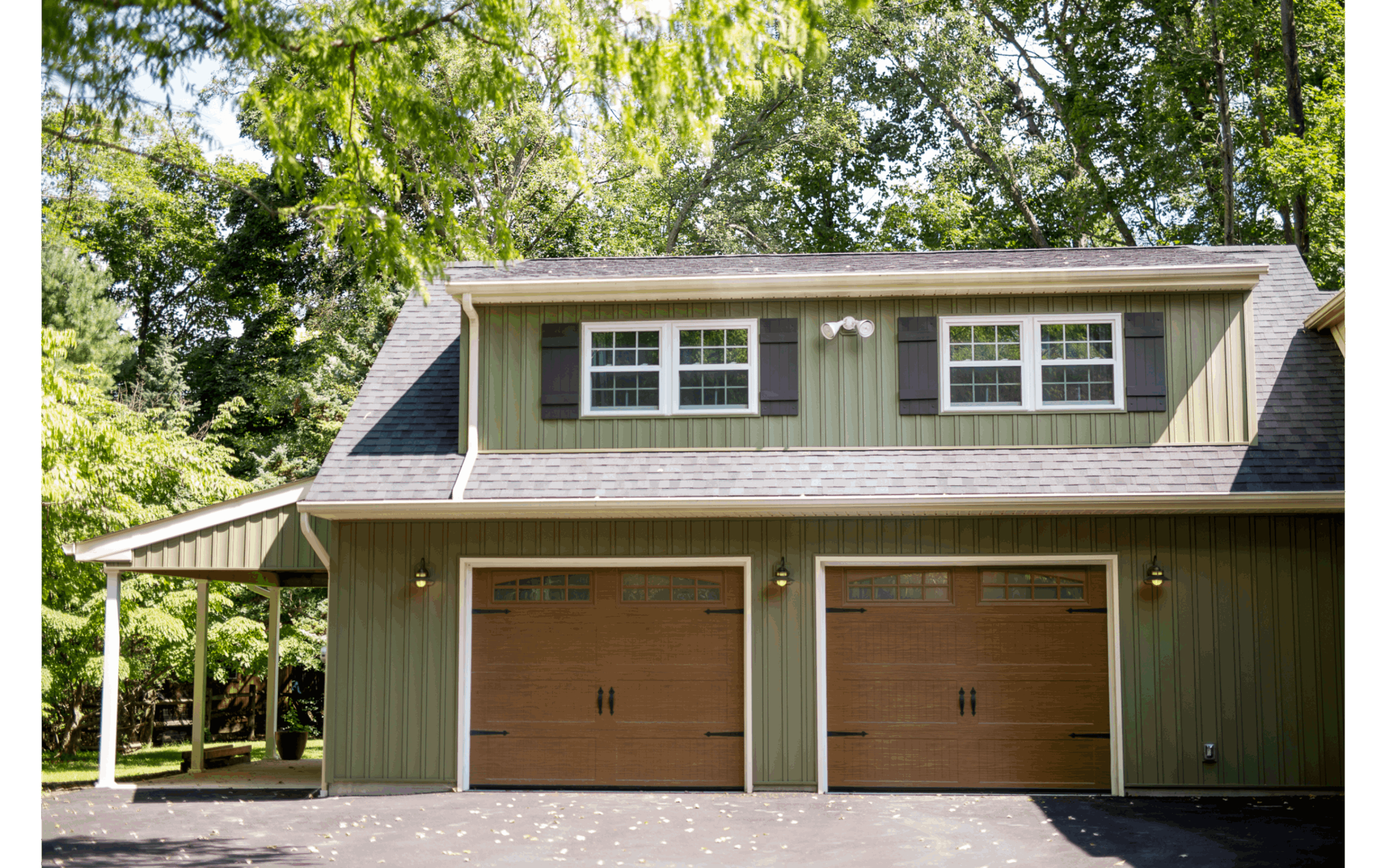 Two door garage addition on green homw