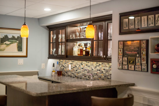 Remodeled basement with a bar area.