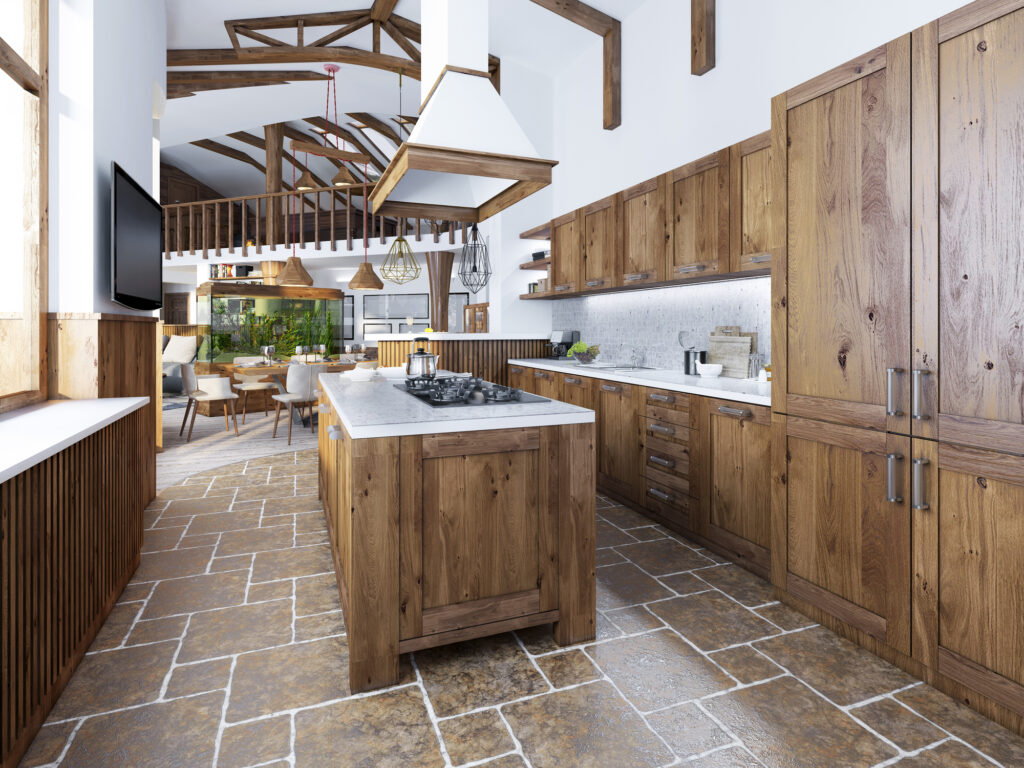 The large kitchen in the loft style with an island in the middle. Wooden furniture with white worktops and mosaic with integrated appliances.