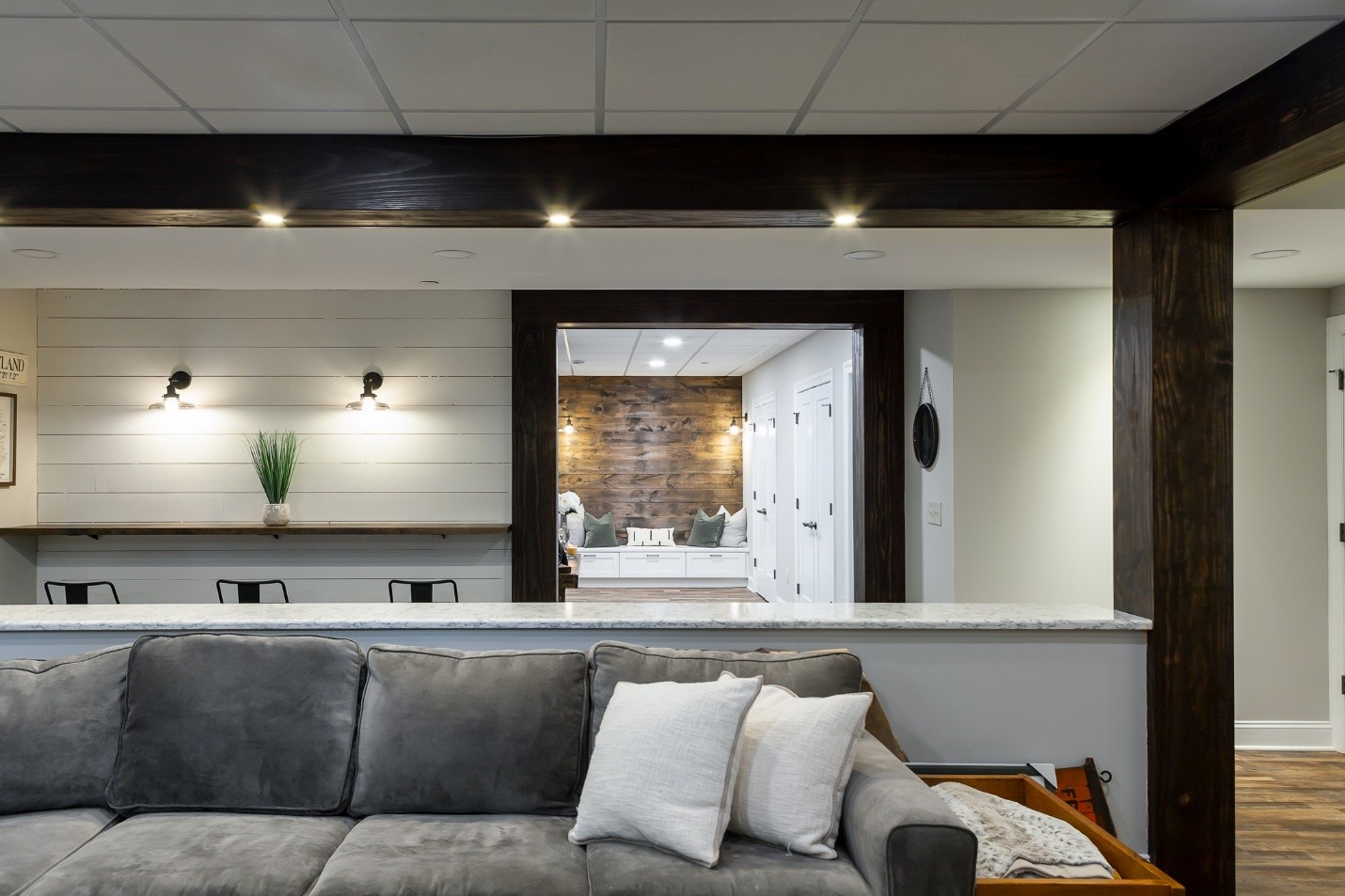 Modern bonus room with white, grey, and dark brown colors featured