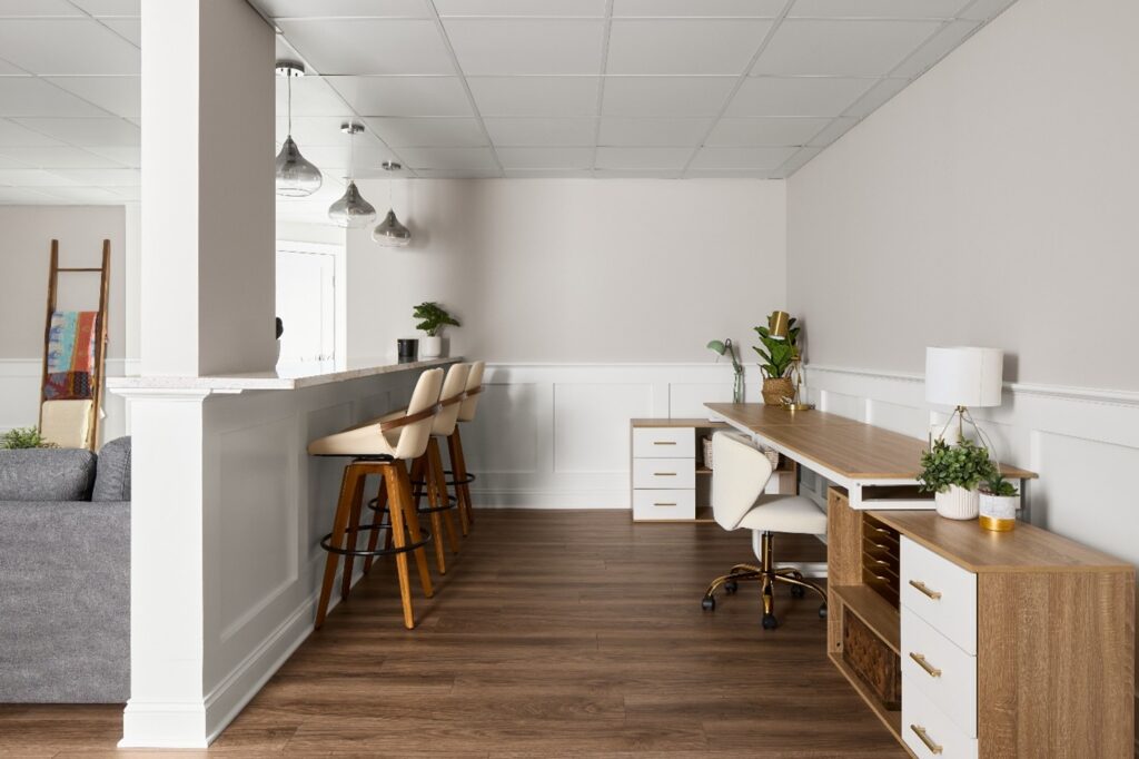 Light and modern bonus room with desk setup